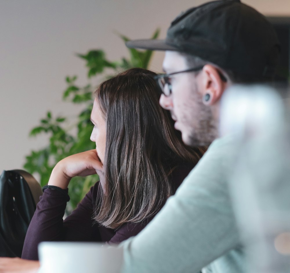 Two colleagues reviewing a specification on a laptop